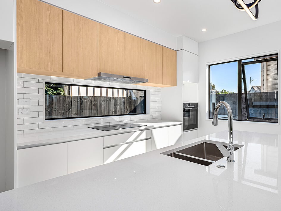 New white kitchen with timber accents in Eden Construction&rsquo;s new build house on Mountain Road, Mangere Bridge, Auckland.