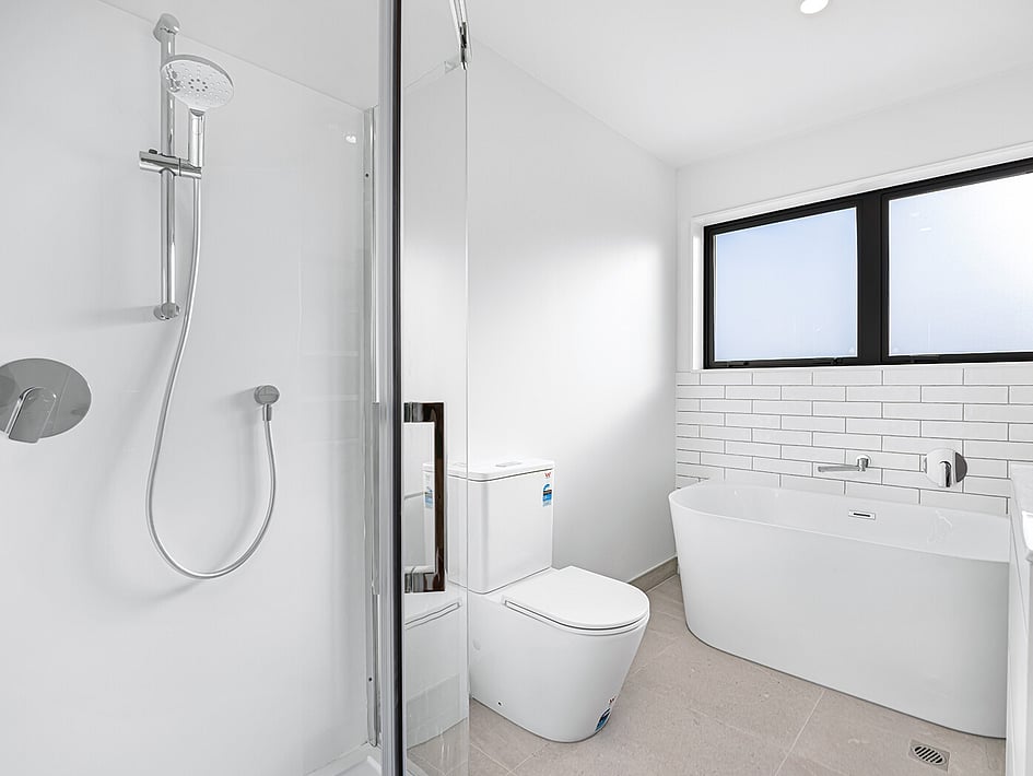 Bathroom with white subway tiles in Eden Construction&rsquo;s new build house on Mountain Road, Mangere Bridge, Auckland.