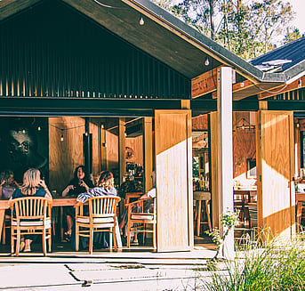 People conversing in the wharenui at Arete