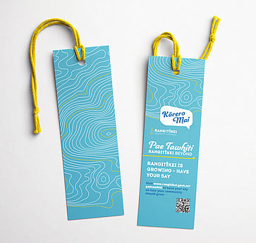 2 light blue bookmarks with information about the consultation displayed on light blue with yellow rope