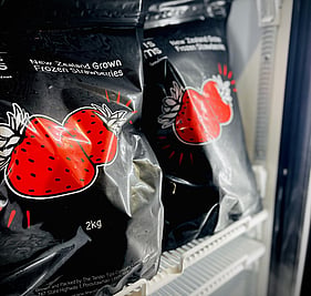 Lewis Farms frozen strawberries packaging in a fridge