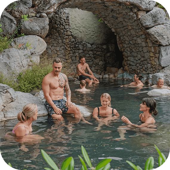 People relaxing in the Deluxe Lake Spa pools at Polynesian Spa overlooking Lake Rotorua