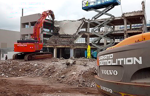 Commercial multi story building being demolished in Hamilton by Waikato Demolition contractors
