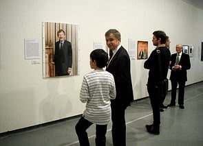 Opening night guests contemplate Sir Ron Brierley