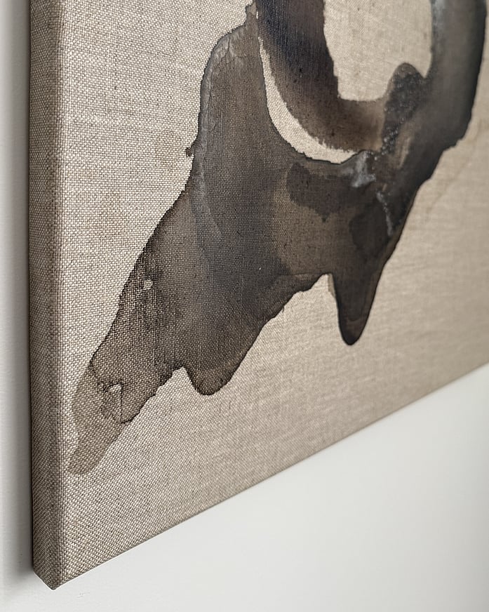 Side view of the painting in acrylic, ink and salt on natural linen; deep brown tones with layered brown washes and canvas edge depth shown