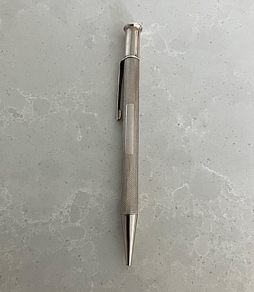 Elegant sterling silver mechanical pencil with panel available for future owner's monogram. It was made in Birmingham in 1965.