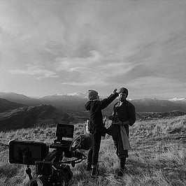 Laura working on set in the mountains touching up an actors make up.