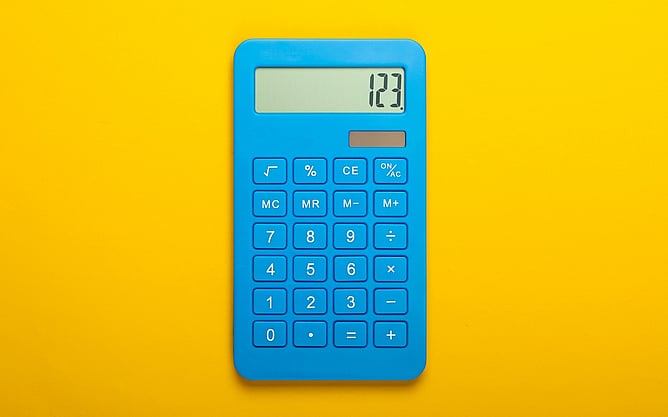 A blue calculator on a bright yellow background