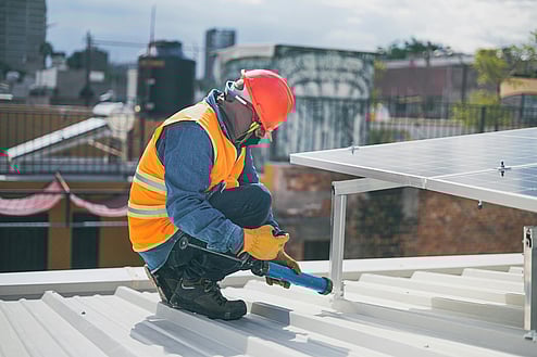 tradie on roof finsihing up a job